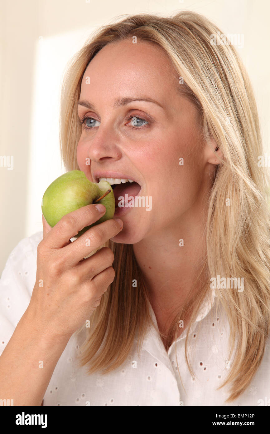 WOMAN EATING A GREEN APPLE Stock Photo Alamy