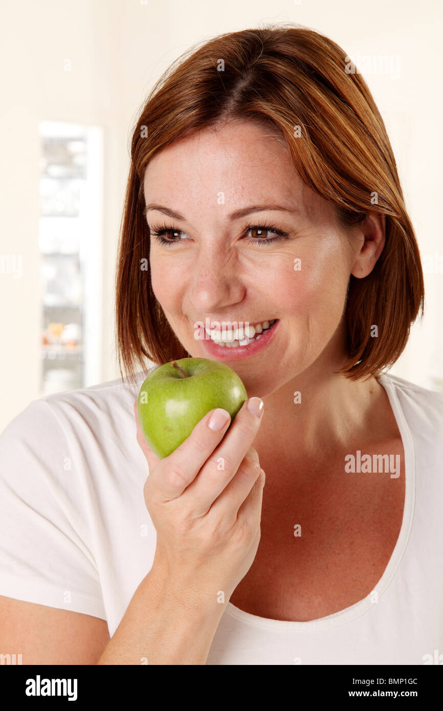 WOMAN EATING A GREEN APPLE Stock Photo Alamy