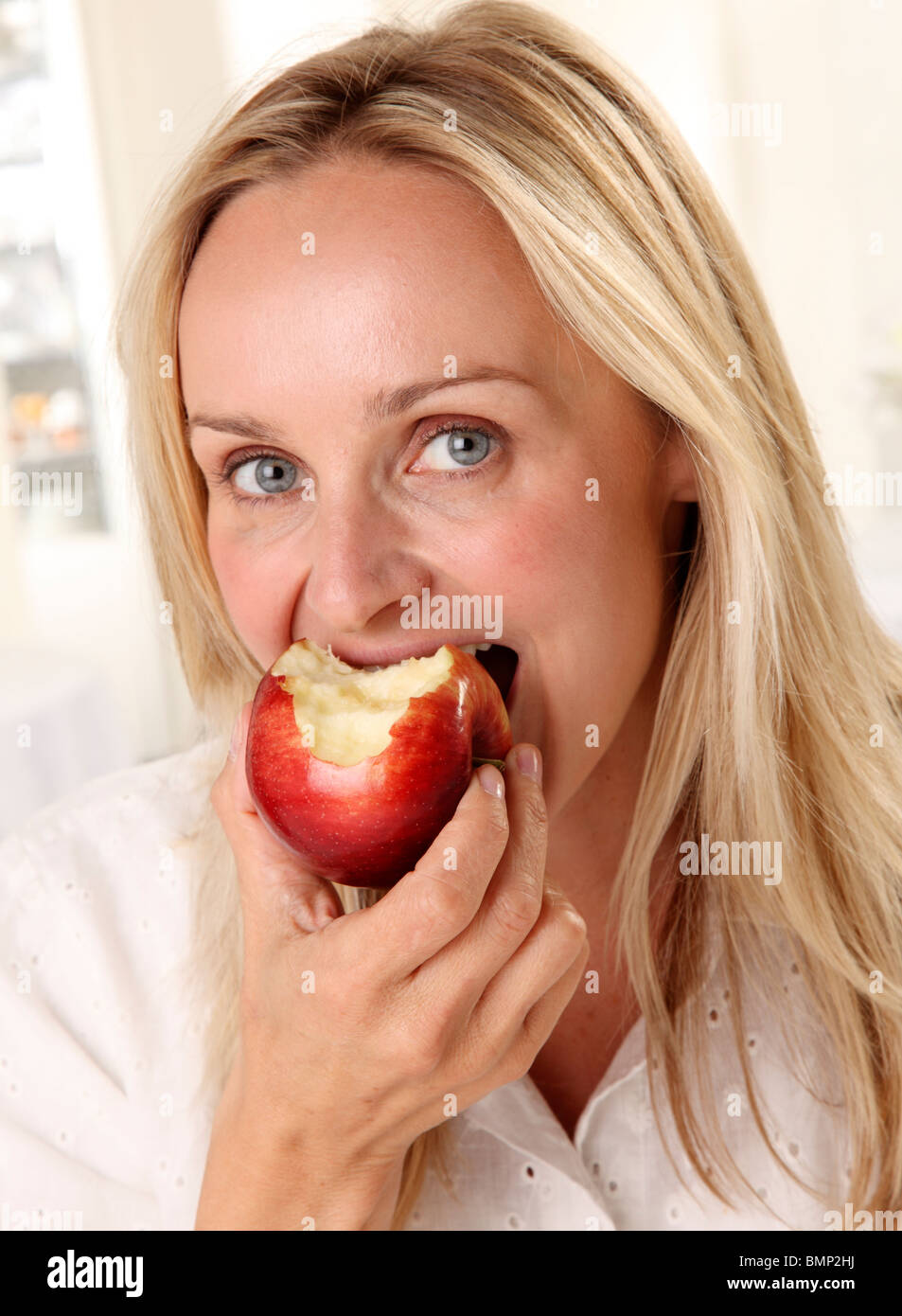 WOMAN EATING A RED APPLE Stock Photo Alamy