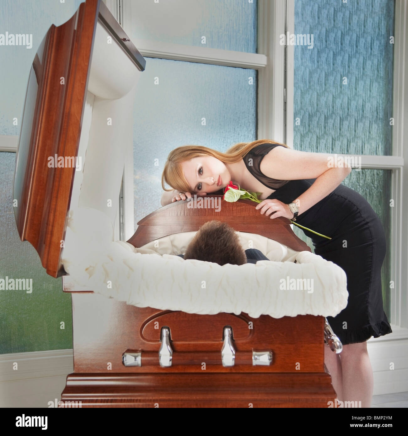 Edmonton, Alberta, Canada; A Young Woman Holds A Rose And Lays Her Head