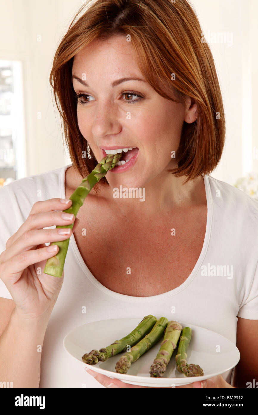 WOMAN EATING ASPARAGUS Stock Photo Alamy