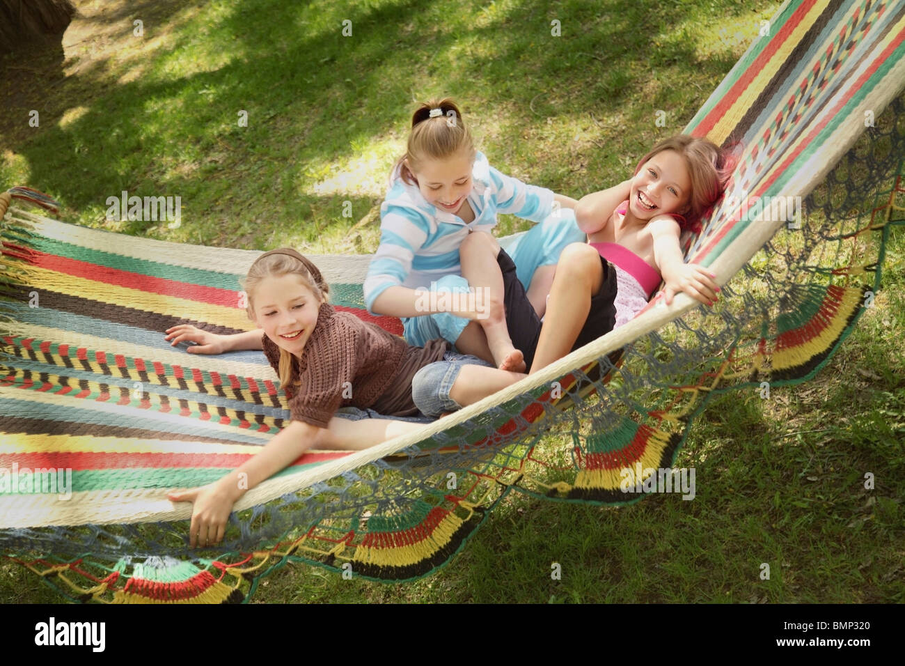 Edmonton, Alberta, Canada; Three Girls Playing In A Hammock Stock Photo