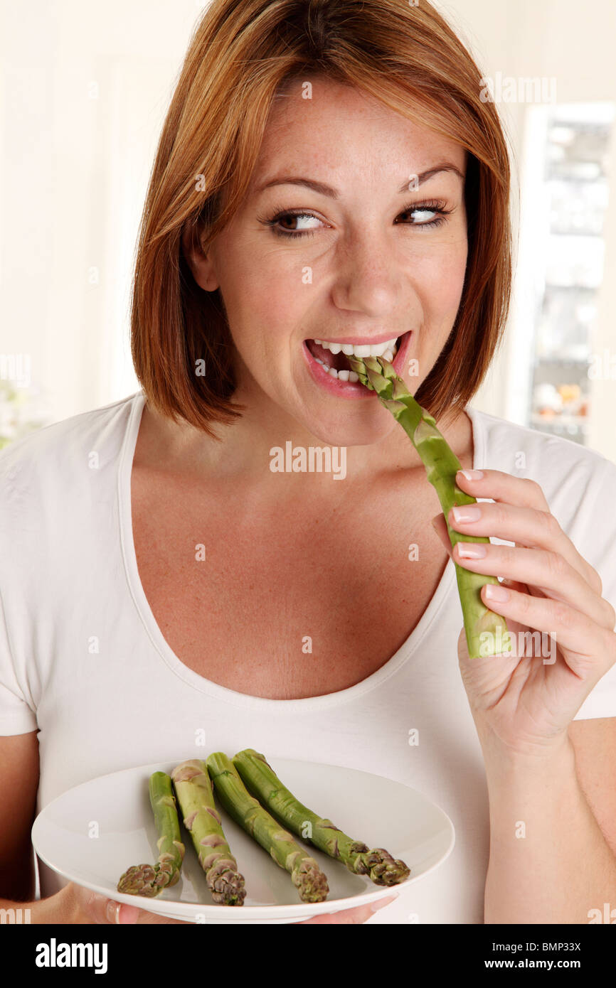 WOMAN EATING ASPARAGUS Stock Photo Alamy