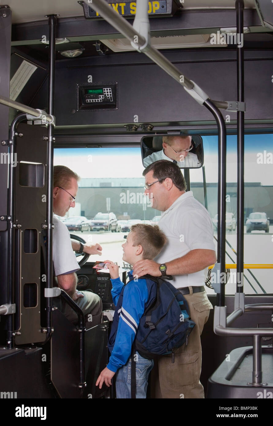 St. Albert, Alberta, Canada; A Father And Son Talking To The Driver As They Get On The City Bus Stock Photo