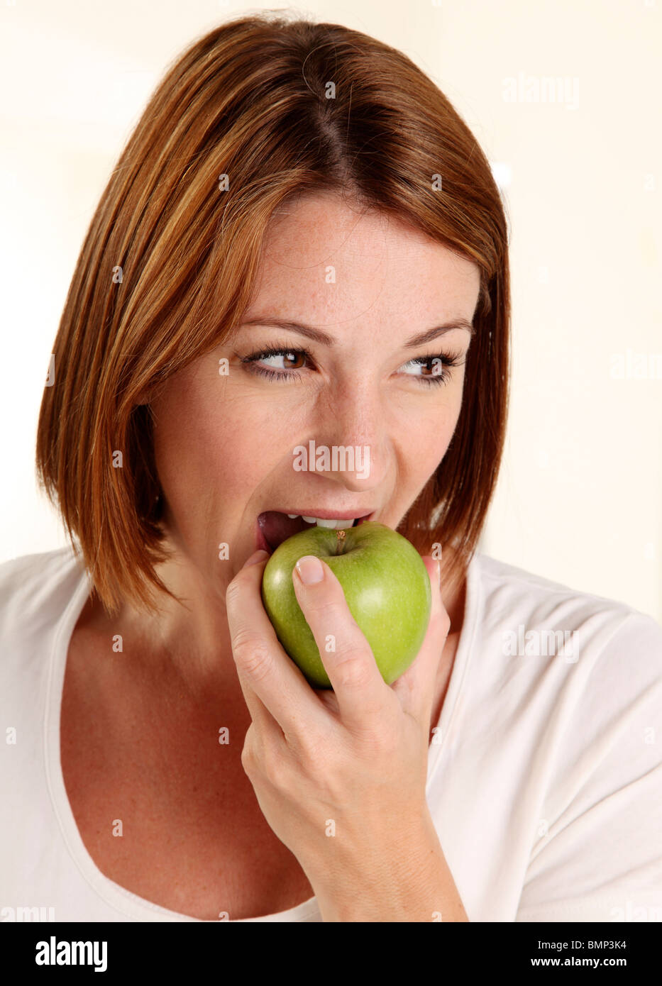 WOMAN EATING A GREEN APPLE Stock Photo Alamy