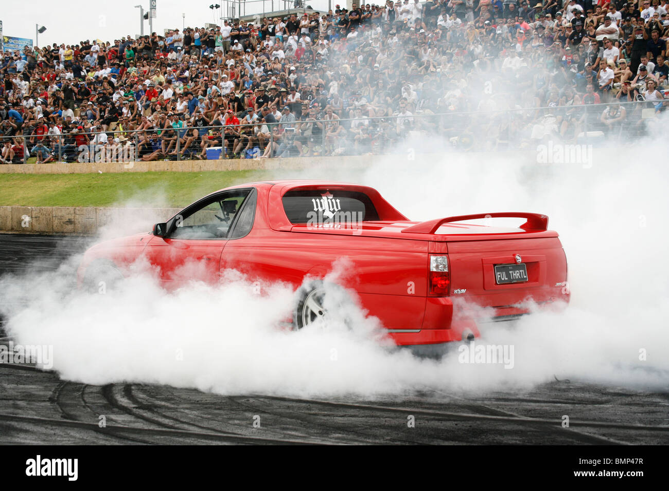 Australian Holden Commodore utility (ute, or pick up truck) performing a burnout at an Australian summer car show Stock Photo