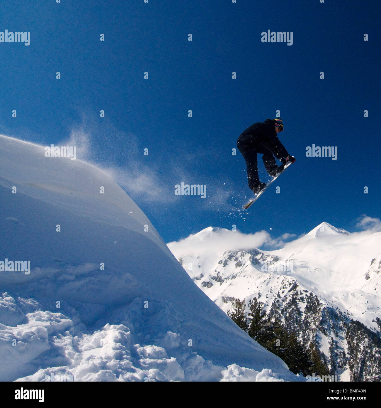 Ash Newness pulls of a 'Rocket Air' grab, from a natural lip in the Bulgarian back country  in Bansko. Stock Photo