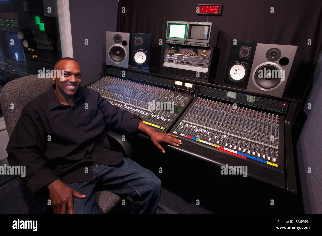 Fort Lauderdale, Florida, United States Of America; A Man Sitting At The Sound Board In A Recording Studio Stock Photo