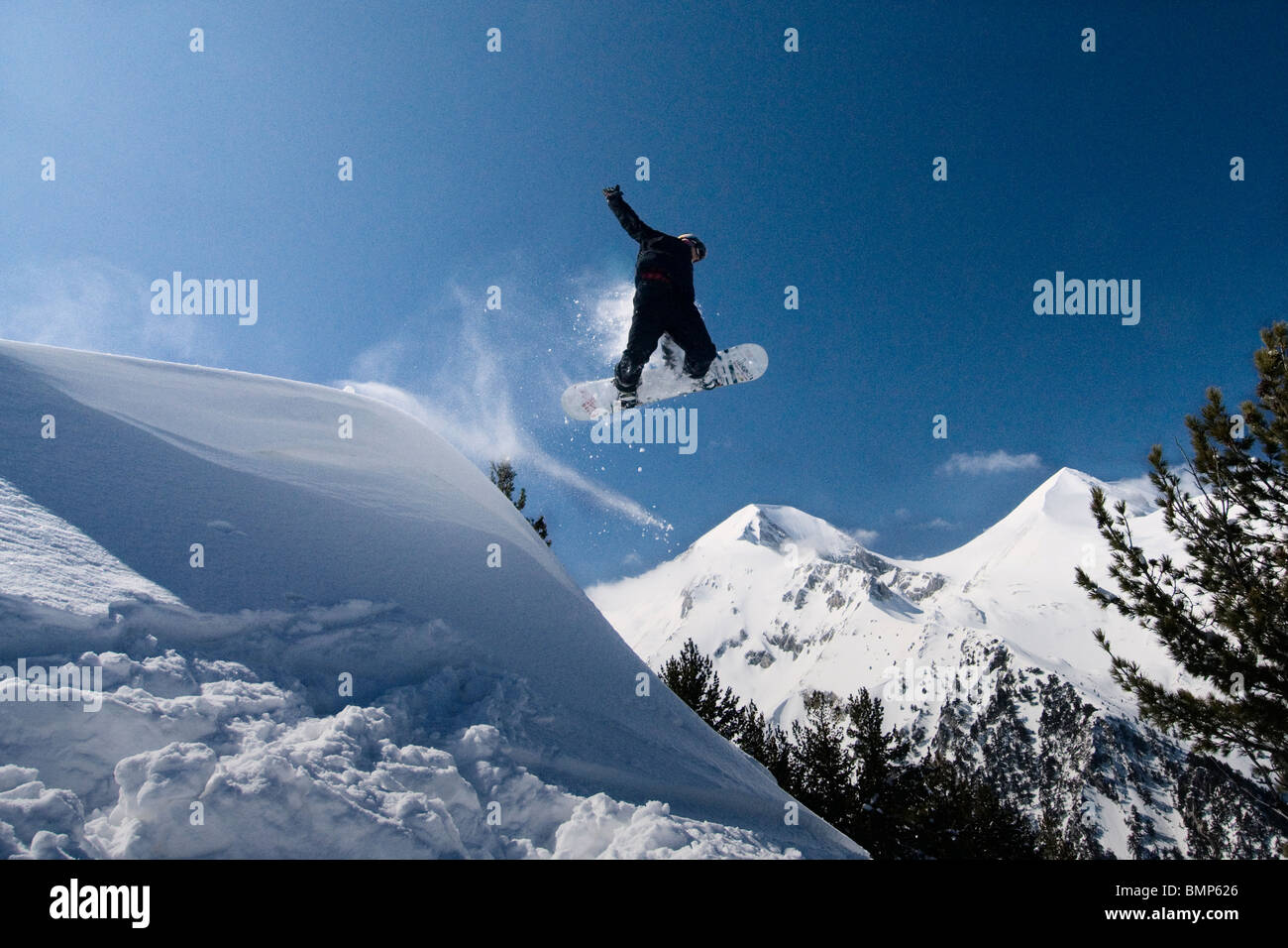 Ash Newness pulls of a 'Method' grab, from a natural lip in the Bulgarian back country  in Bansko. Stock Photo