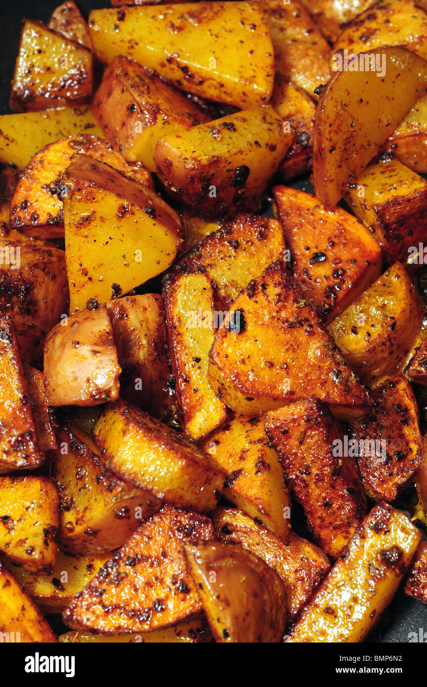 Home fried potatoes iln a cast iron skillet with serving plates Stock Photo  - Alamy