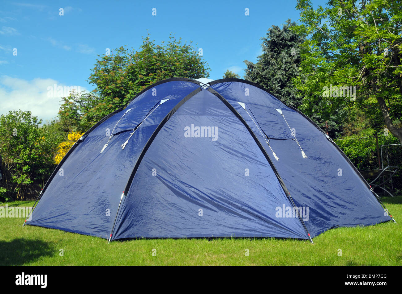 A blue tent in a back garden lawn. Stock Photo
