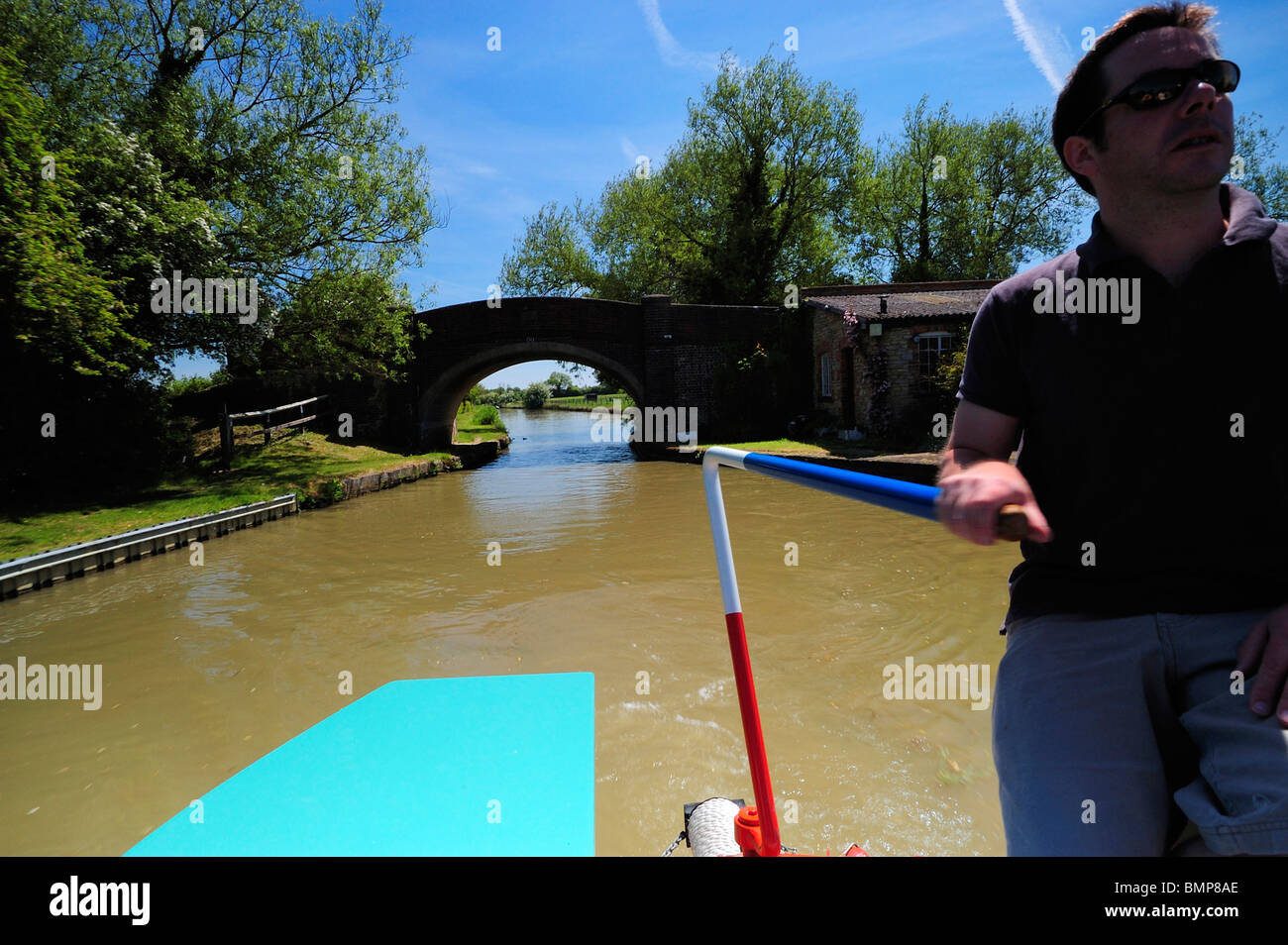 Driver Operating Tiller, Grand Union Canal, UK Stock Photo