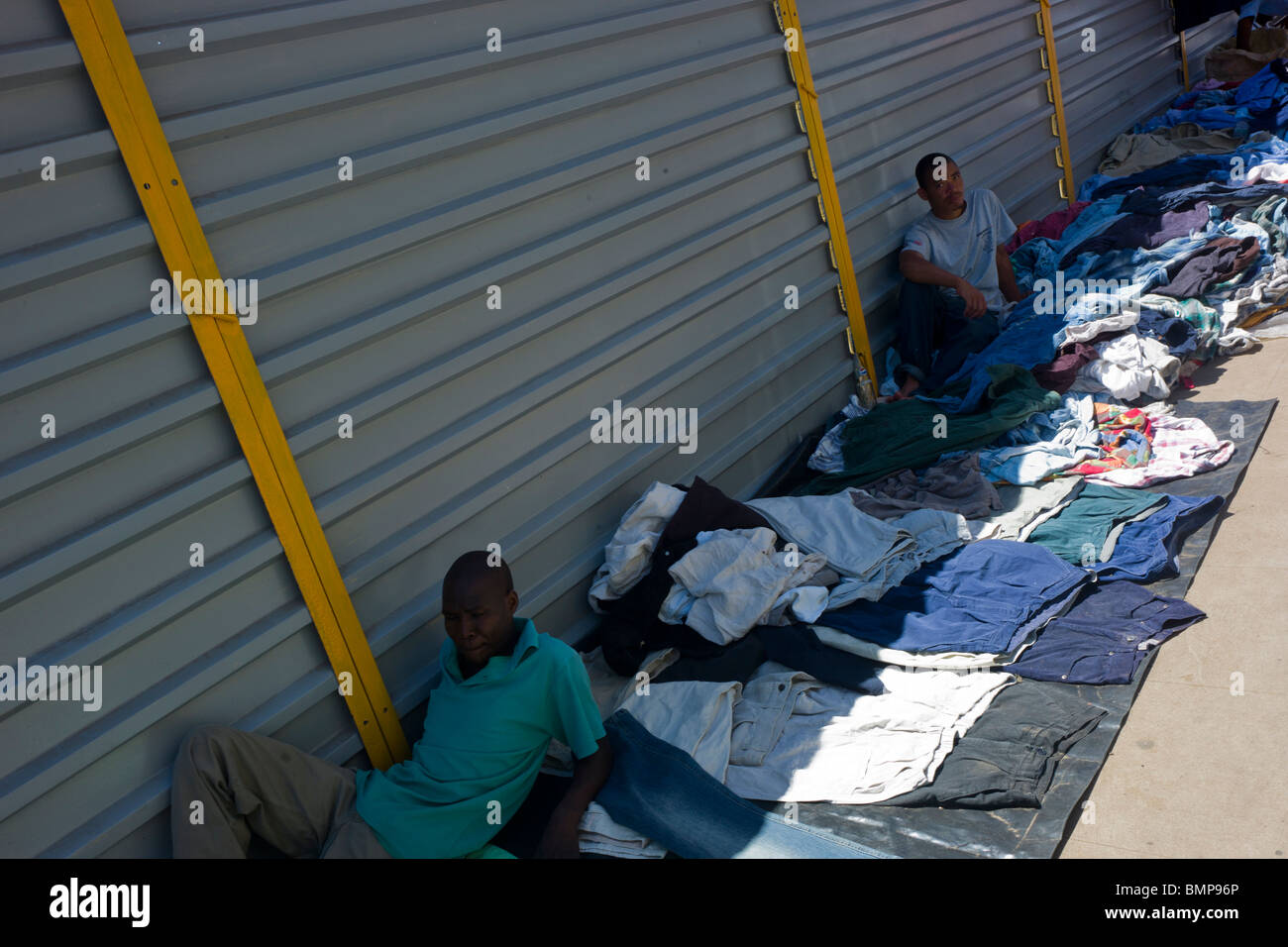 Ambulant vendors of blue jeans and tee shirts in the streets of Maputo, Mozambique. Stock Photo