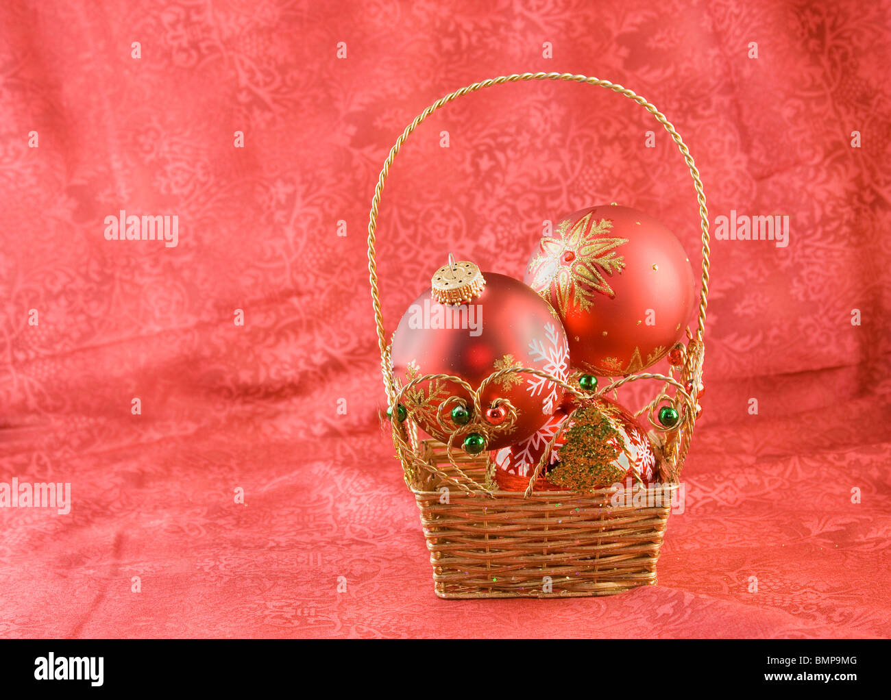 red Christmas snowflake patterned baubles in a basket with copyspace Stock Photo