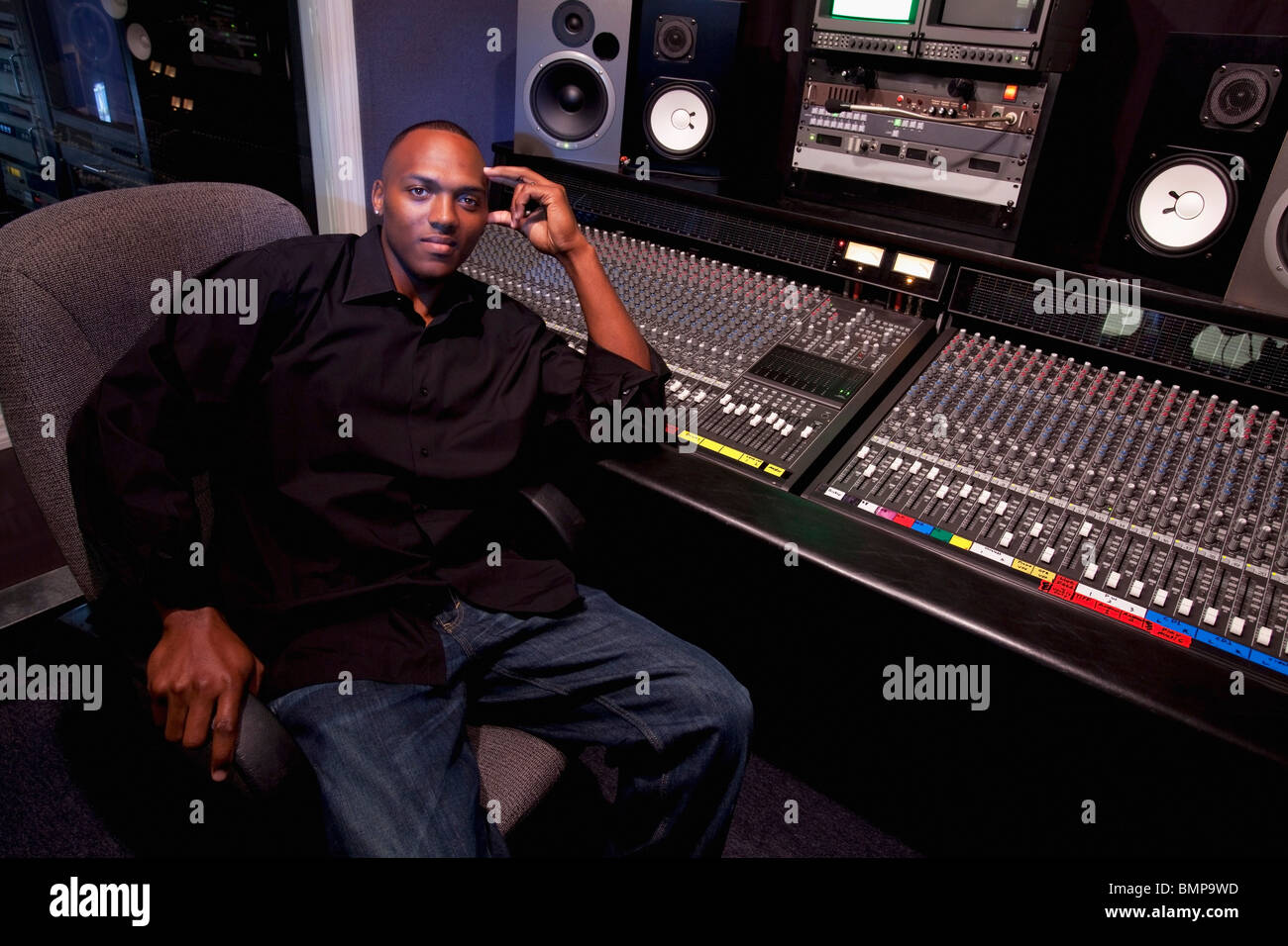 Fort Lauderdale, Florida, United States Of America; A Man Sitting At A Sound Board In A Recording Studio Stock Photo