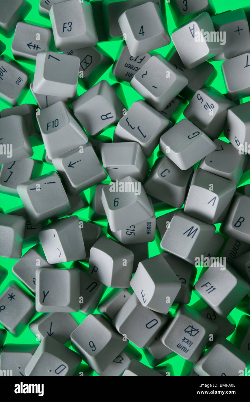 A photograph from above of old computer keyboard keys scattered randomly. Stock Photo