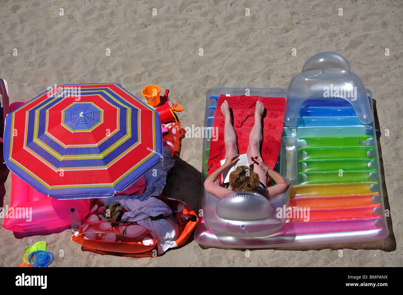 Beach airbeds and parasol, Portinatx, Ibiza, Balearic Islands, Spain Stock Photo