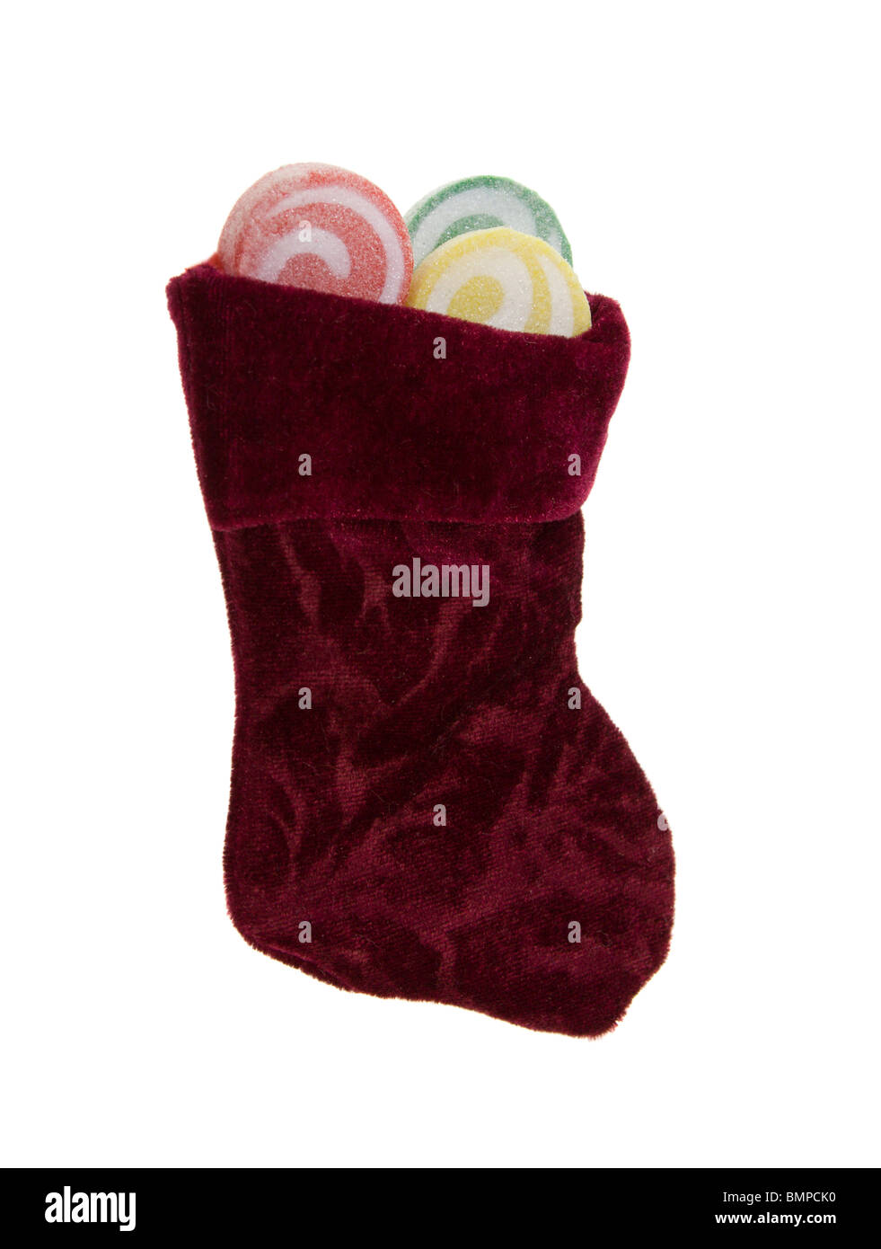 Christmas stocking with swirl lollipops on white Stock Photo