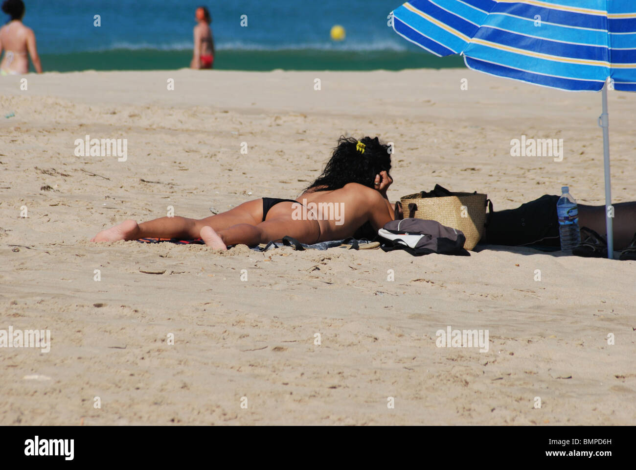 Woman sunbathing on the beach, Zahara de los Atunes, Costa de la Luz, Cadiz Province, Andalucia, Spain, Western Europe. Stock Photo