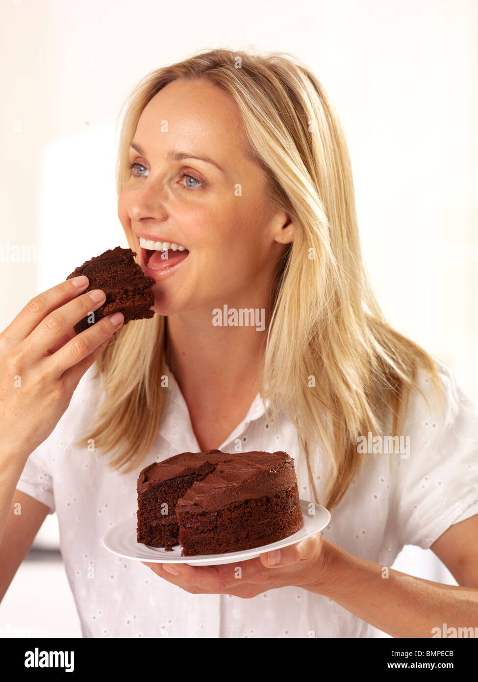 Woman binge eating kitchen hires stock photography and images Alamy
