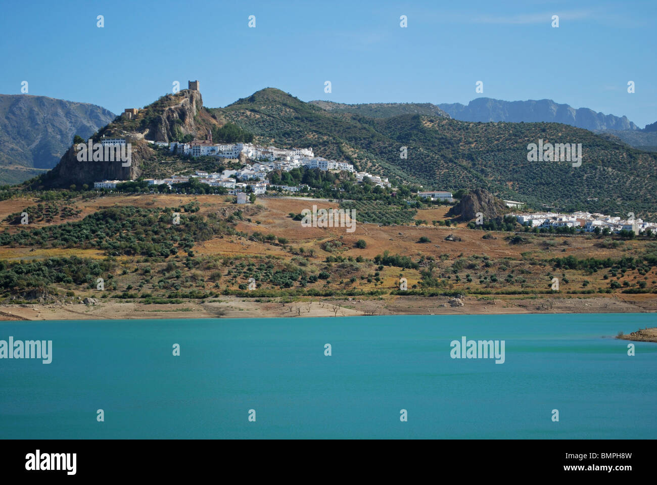 View of whitewashed village (pueblo blanco) and lake (embalse de Zahara ...