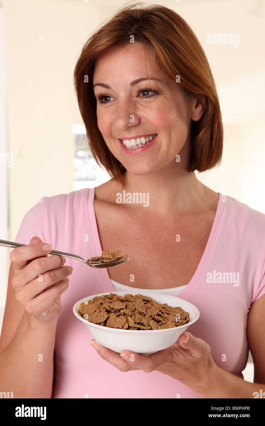 WOMAN EATING BRAN FLAKES BREAKFAST CEREAL Stock Photo Alamy