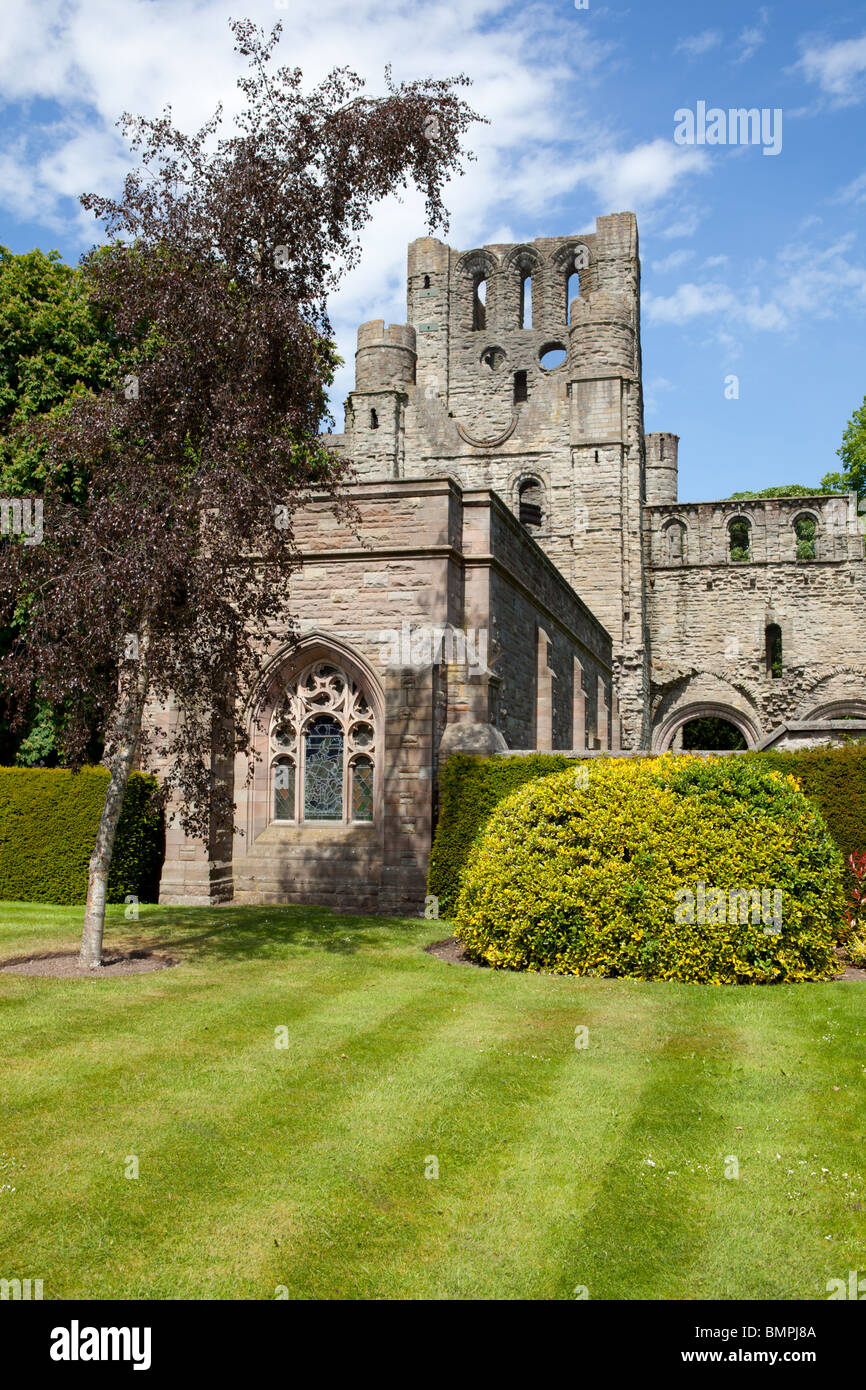 The ruins of Kelso Abbey as seen from the park gardens on a beautiful sunny afternoon. Stock Photo