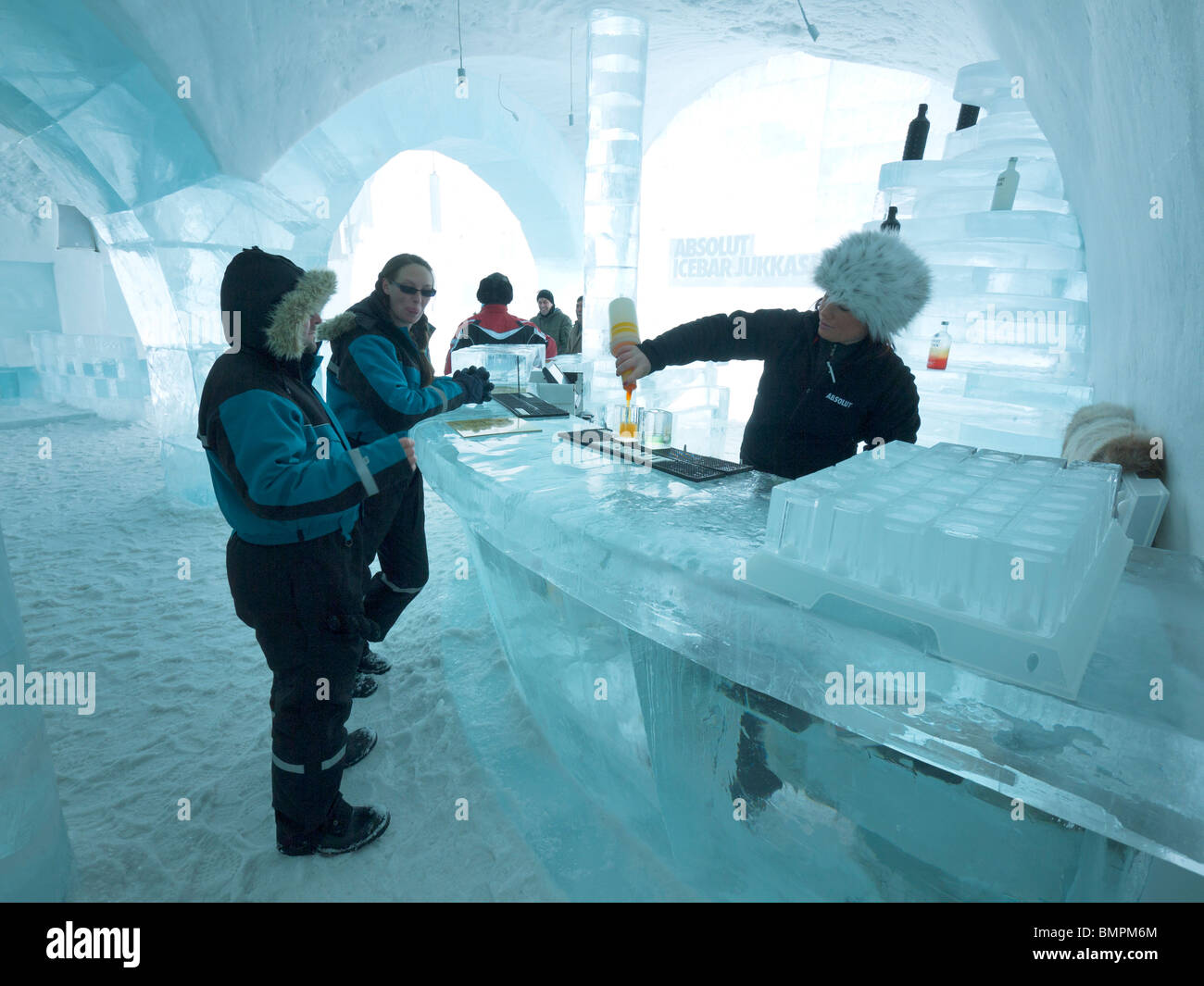 Tourists stand in the Absolut Icebar in the Jukkasjärvi icehotel. Stock Photo