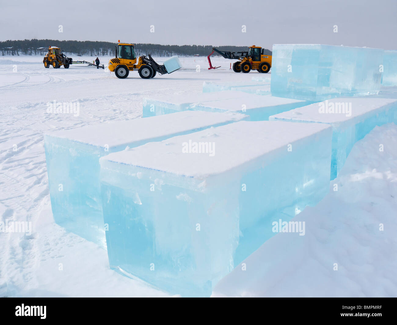 Big blocks of ice are being cut and lifted out from the frozen Torne