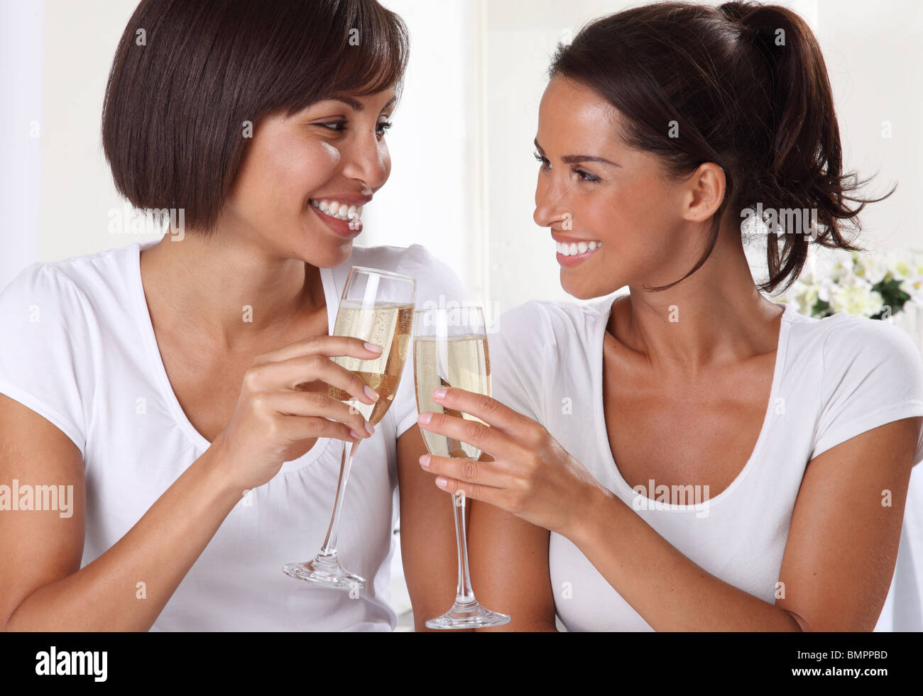 TWO WOMEN DRINKING CHAMPAGNE Stock Photo