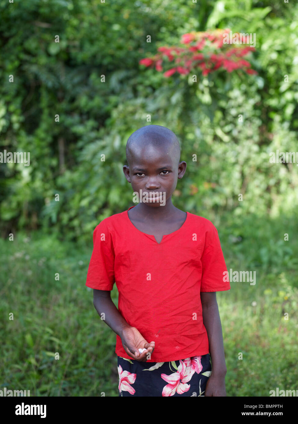 Small black boy wearing a bright red top after the Rwandan genocide Stock Photo