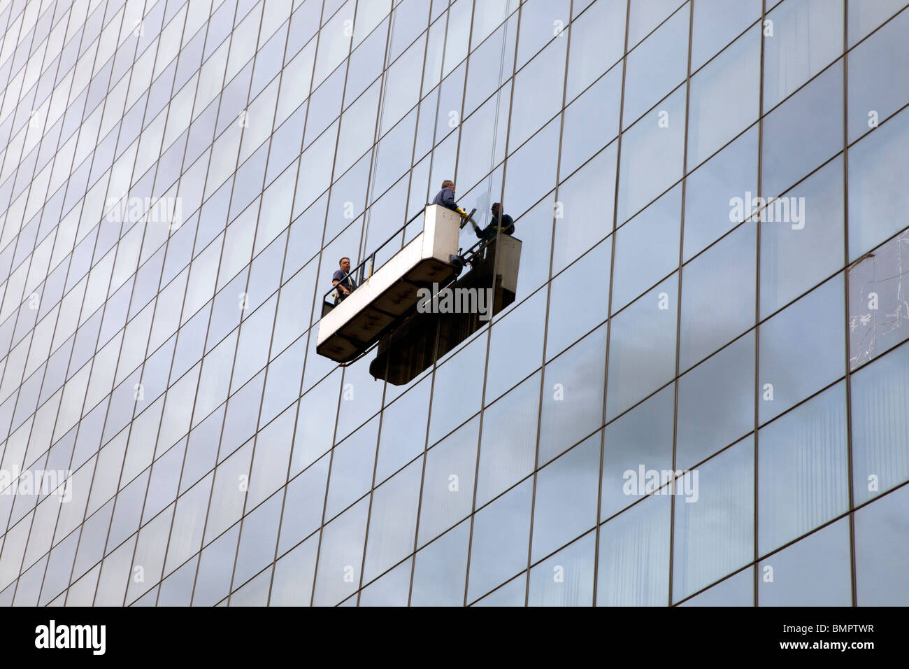 Window cleaners in cradle on office block in Old Street, London Stock Photo