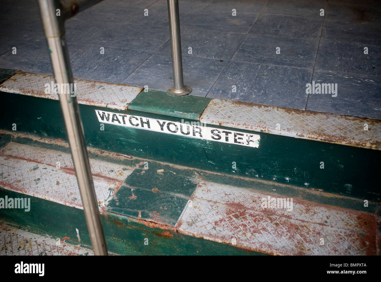 Watch Your Step is painted onto the steps to a vintage trolley awaiting restoration in Brooklyn in New York Stock Photo
