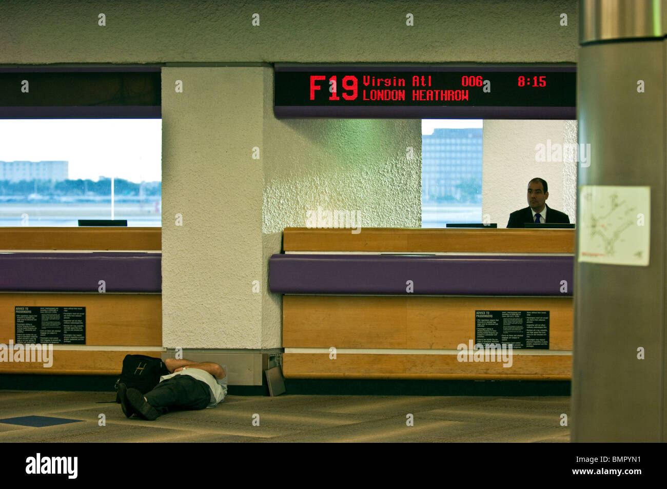 sleeping at the airport check in desk Stock Photo
