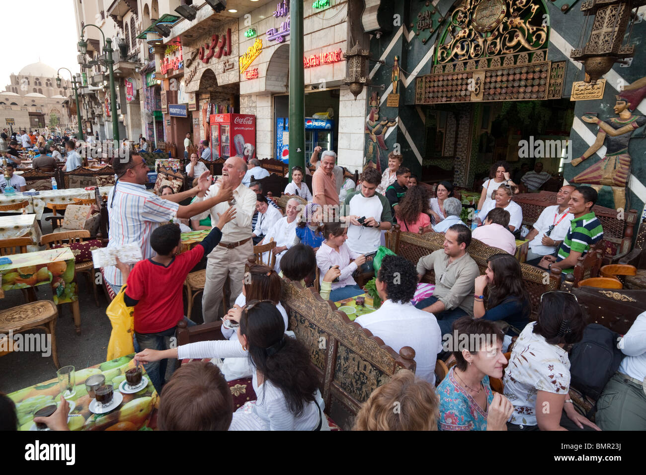 People congregating in the restaurants and cafes of the Islamic quarter ...