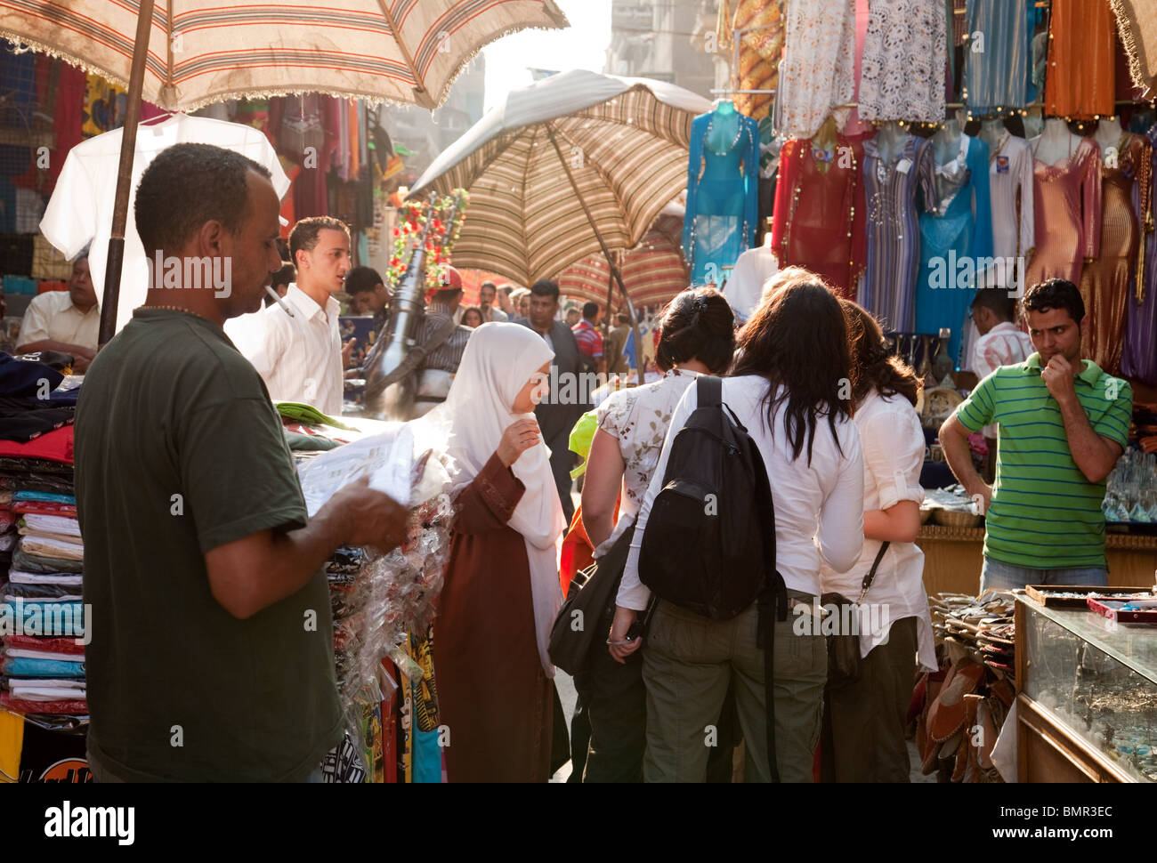 Market Cairo; Western tourists shopping with local people in the crowded Khan el Khalili market stalls, Islamic quarter, Cairo, Egypt North Africa Stock Photo