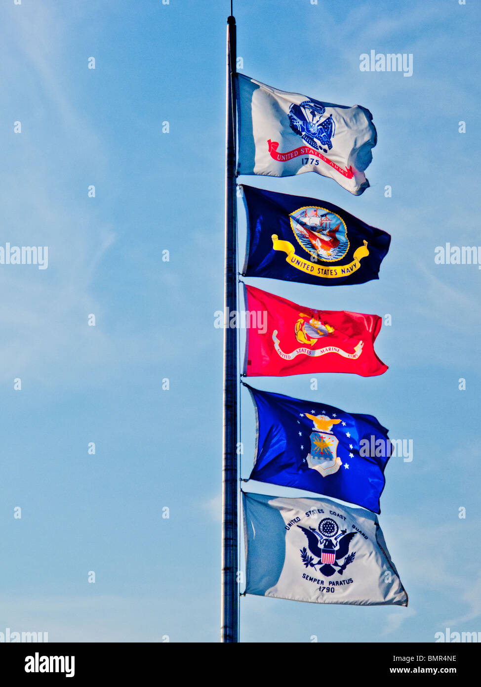 Flags of (top to bottom) the U.S. Army, U.S. Navy, U.S. Marine Corps, U.S. Air Force and U.S. Coast Guard flutter from a pole . Stock Photo