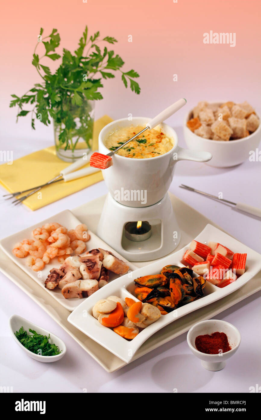 Seafood fondue. Step by step PGGJEKPGGJF1PGGJF5PGGJFC Stock Photo