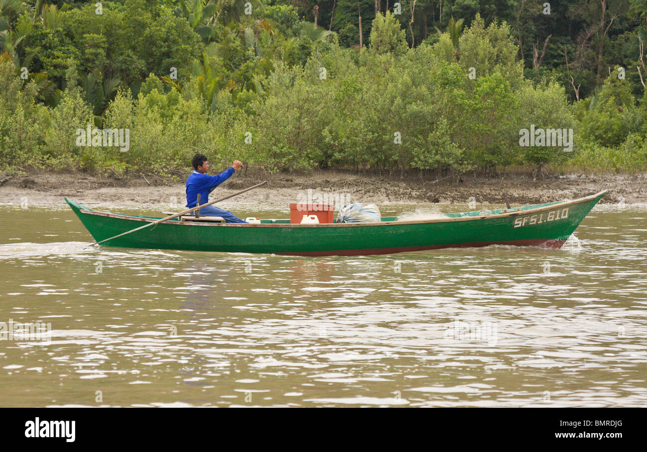 Fisherman in traditional boat, Borneo Stock Photo