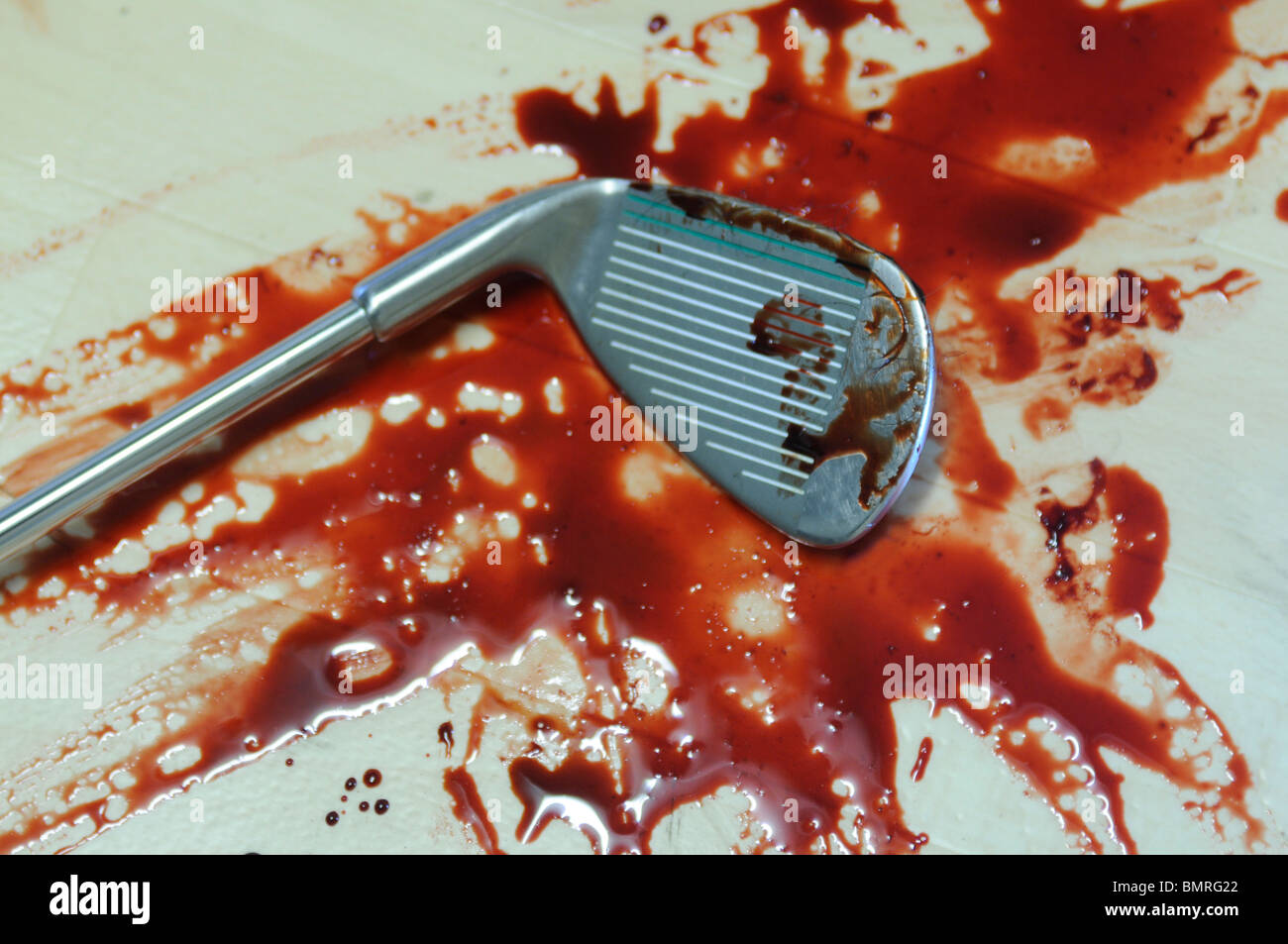 Golf Club Murder weapon, crime scene featuring a golf club in a pool of blood Stock Photo