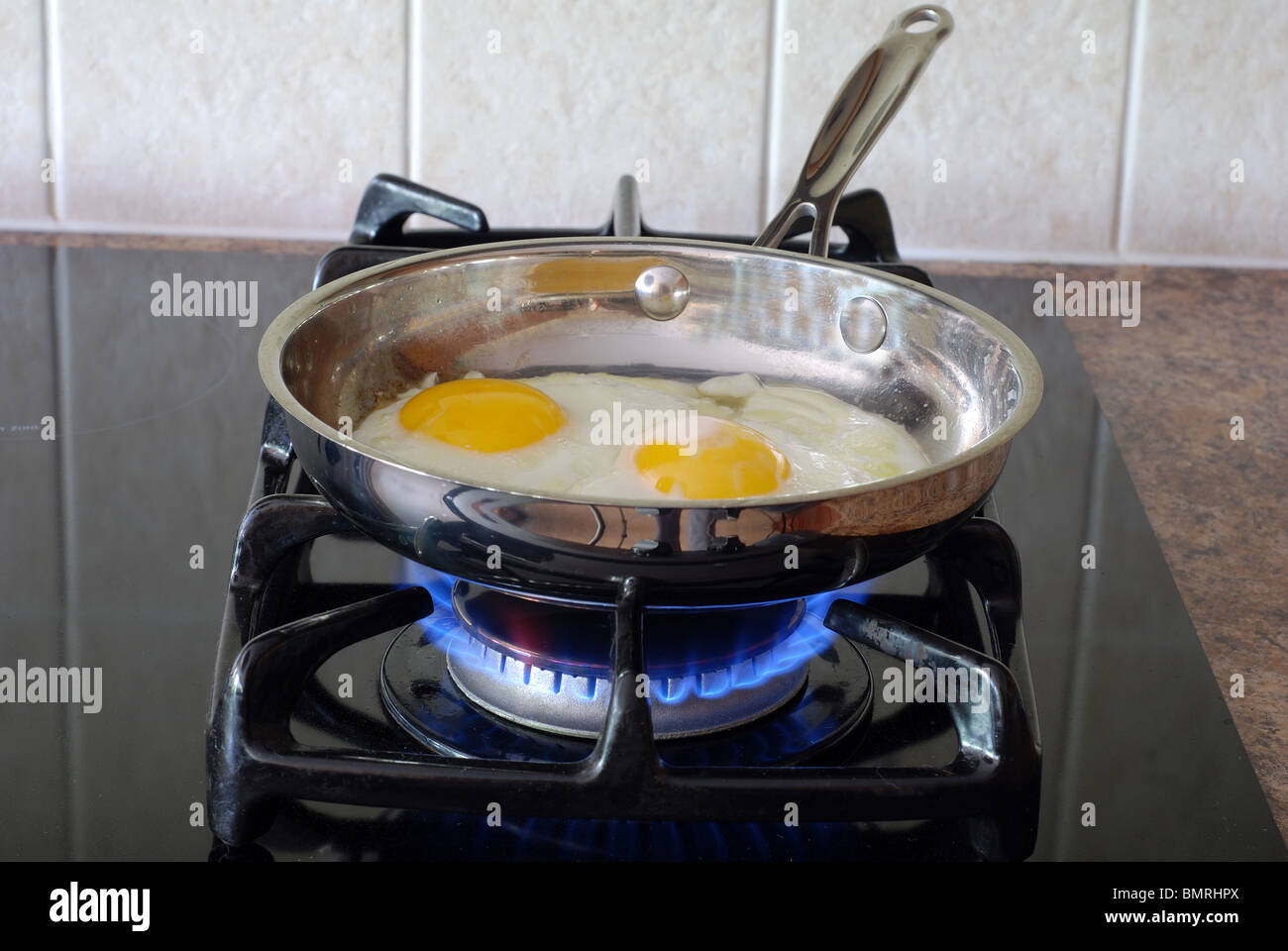 Cooking eggs on a gas stove Stock Photo Alamy