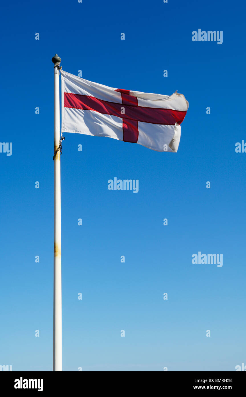 The England flag flying against a blue sky on a summers day. Stock Photo