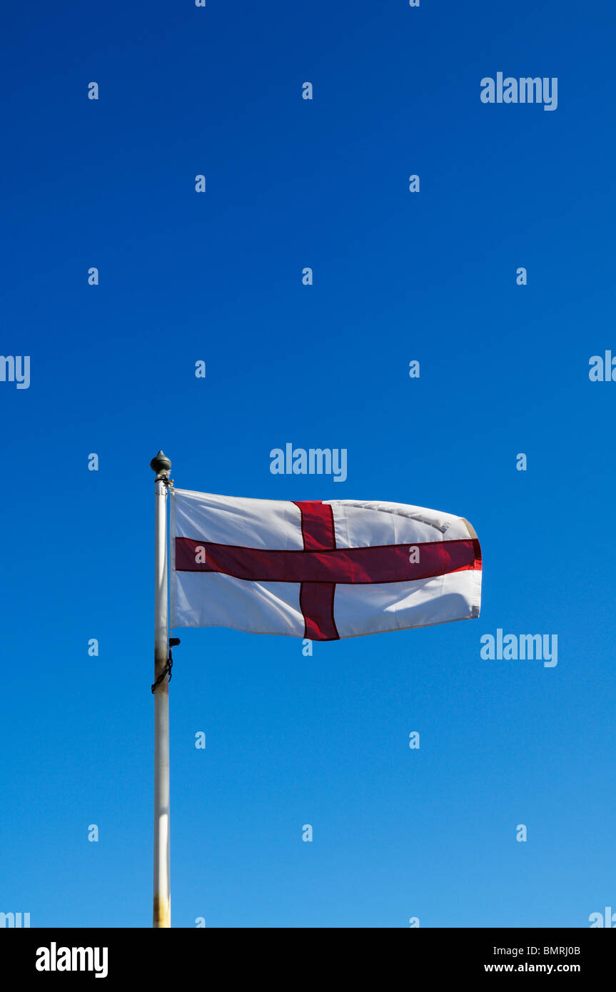 The England flag flying against a blue sky on a summers day. Stock Photo