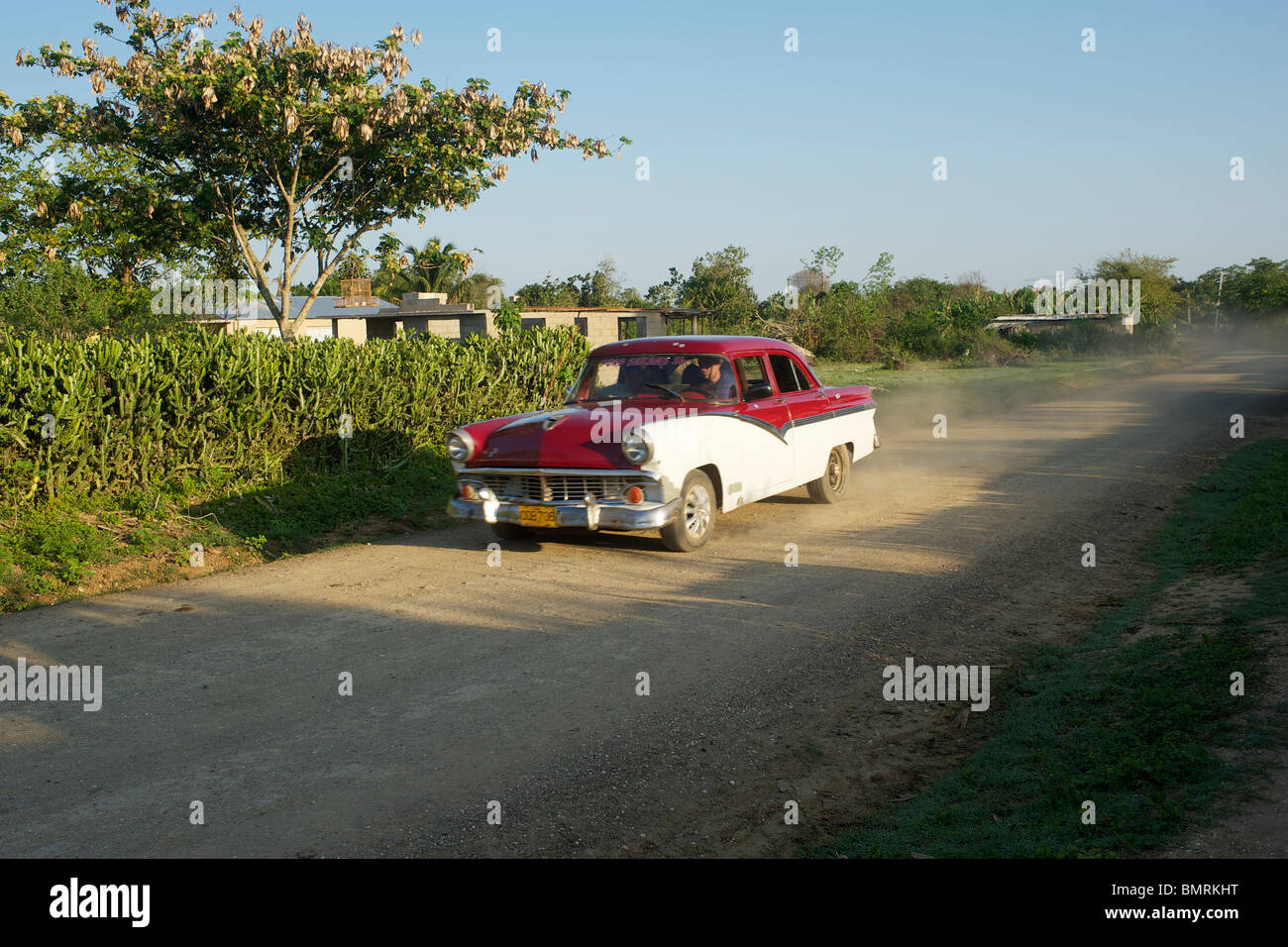 Classic car on a dirt road in Cuba Stock Photo