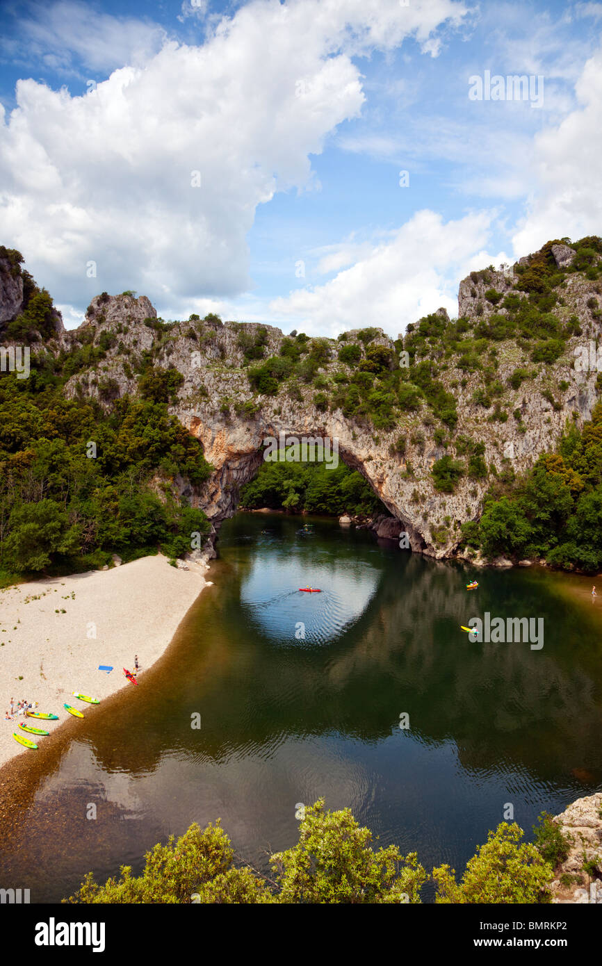 Pont d'Arc, natural stone arch across the Ardèche river, canoes on water and  beach Stock Photo