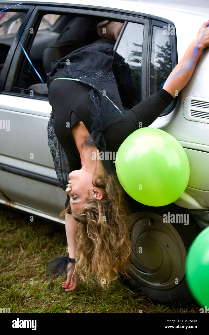 Performance artists performing a car crash. Stock Photo