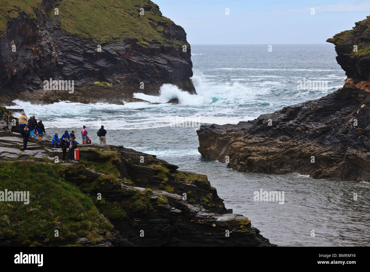 Visitors watching waves breaking on the rocks at Boscastle, Cornwall, England Stock Photo