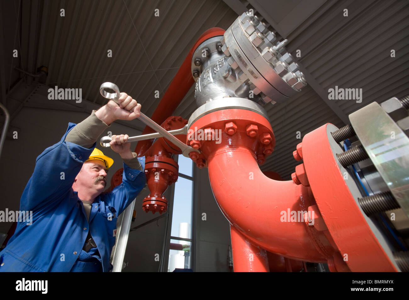 An engineer working on the piping of geothermal generating station, Landau, Germany Stock Photo
