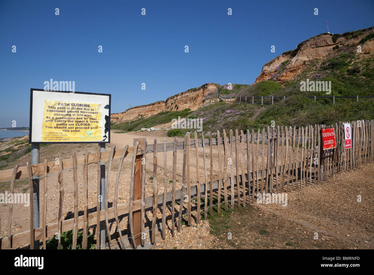 under cliff path closed sign and fencing due to ground movement erosion at Barton on Sea Stock Photo