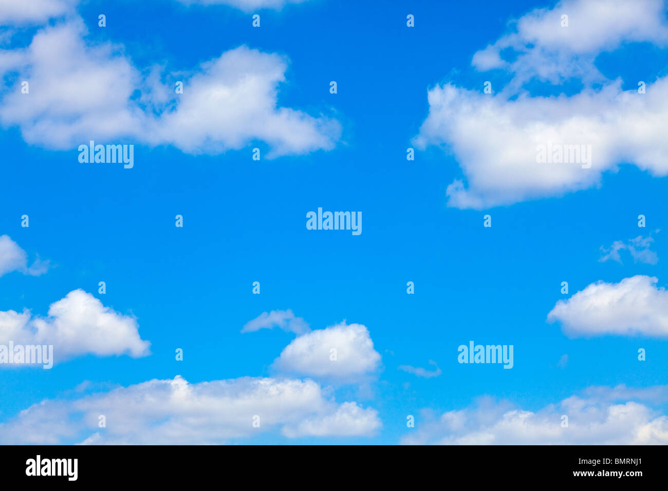 blue sky with white fluffy clouds background Stock Photo